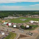 Aerial of the Crossroads Development land for sale outlined at W 12th Street and Interstate 29, with the 178-unit Rhys Apartments site and adjacent sold parcel labeled