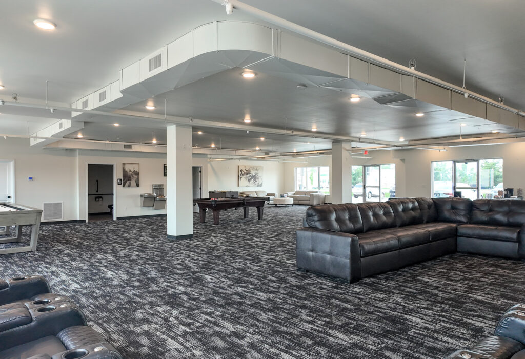 Open finished commercial space with carpet, large windows and flexible floor area