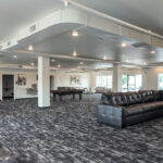 Open finished commercial space with carpet, large windows and flexible floor area