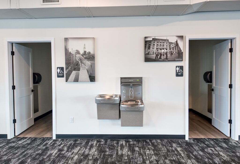 Existing men's and women's restrooms with drinking fountains in the main-level commercial space
