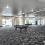 Finished commercial room with carpet, multiple exterior windows and flexible layout