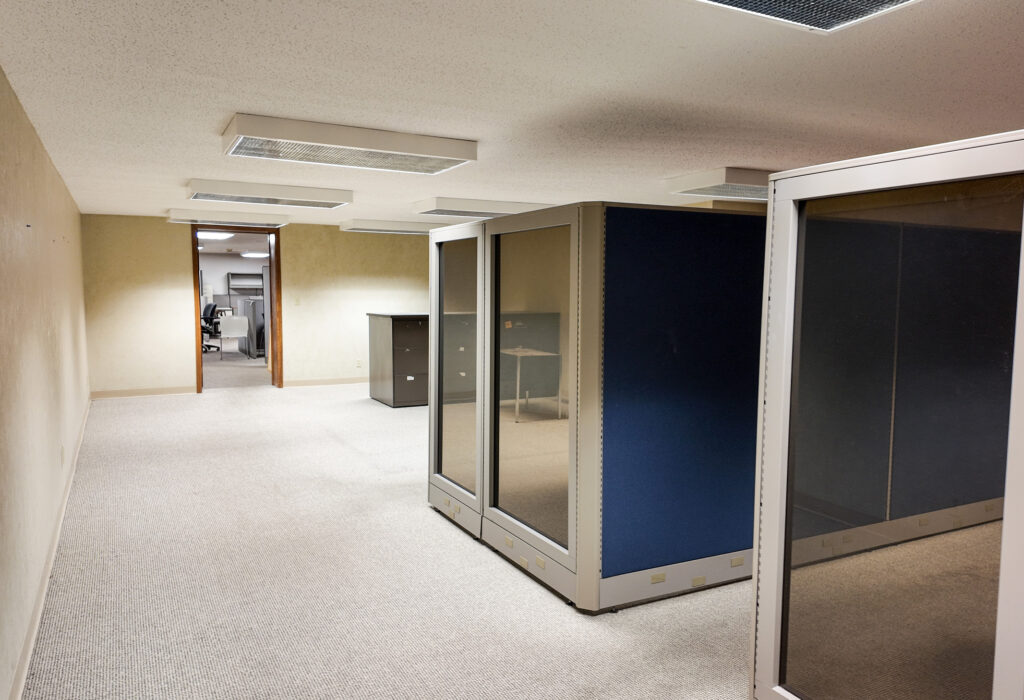 Open lower-level office space with modular workstations