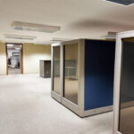 Open lower-level office space with modular workstations