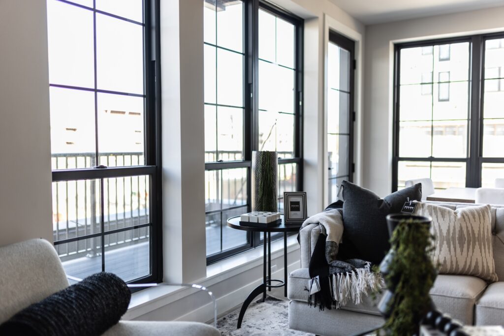 The District Lofts oversized windows overlooking downtown Sioux Falls and the Levitt at Falls Park