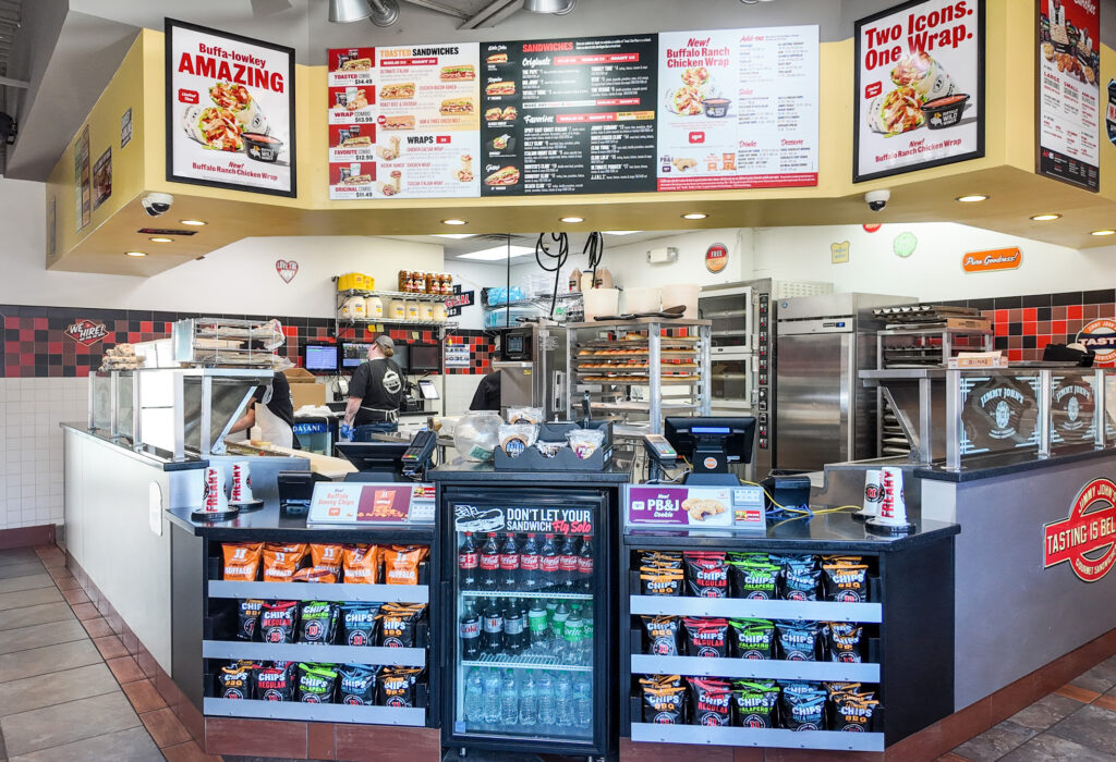 Restaurant interior with customer ordering counter and food preparation area