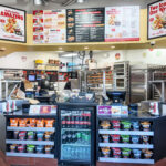Restaurant interior with customer ordering counter and food preparation area