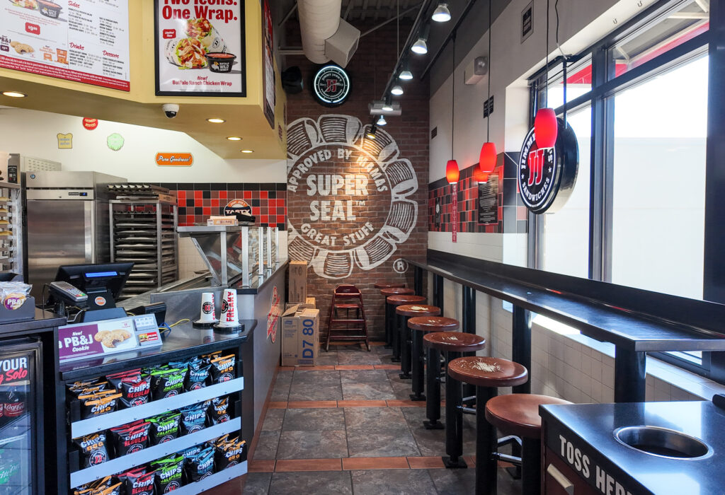 Dining area with storefront windows and counter seating
