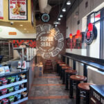 Dining area with storefront windows and counter seating