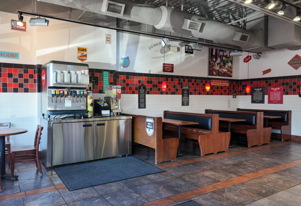 Open restaurant dining area with tables and service counter