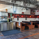 Open restaurant dining area with tables and service counter