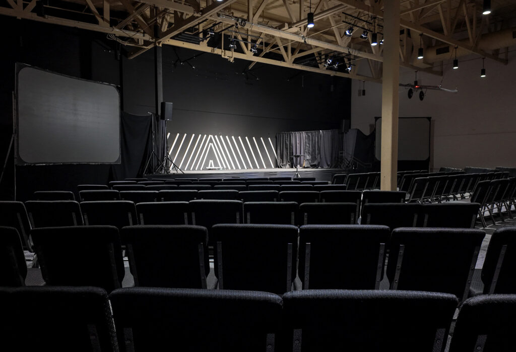 Large multipurpose room facing stage and projection screens