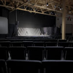 Large multipurpose room facing stage and projection screens