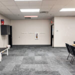 Large carpeted meeting room with tables and open floor area