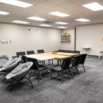 Additional view of flexible meeting room with tables and carpeted flooring