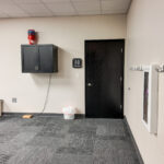 Restroom entrance and built-in wall storage within meeting area
