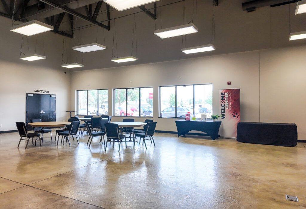 Open lobby and gathering area with storefront windows and polished concrete floors