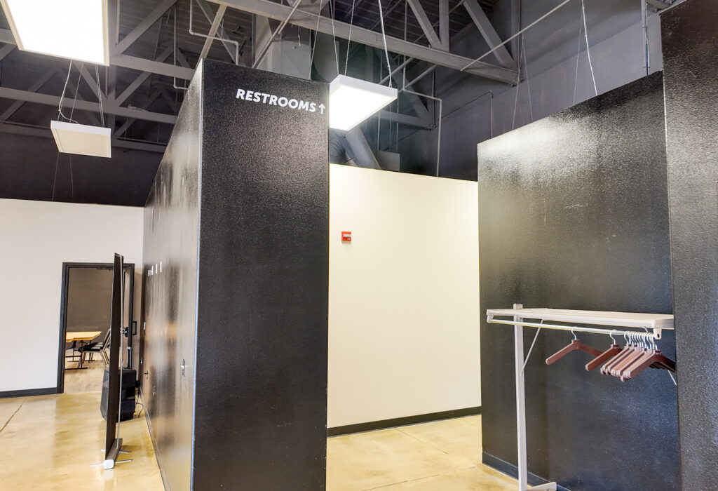 Interior corridor with restroom access and coat storage