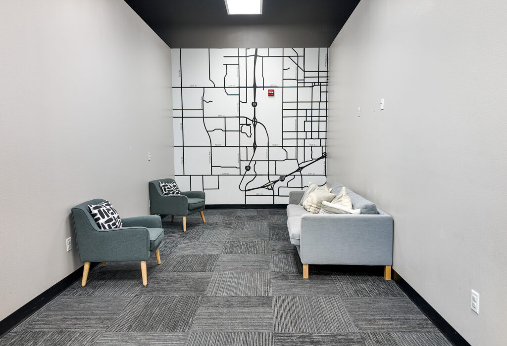 Carpeted sitting or meeting room with built-in wall map