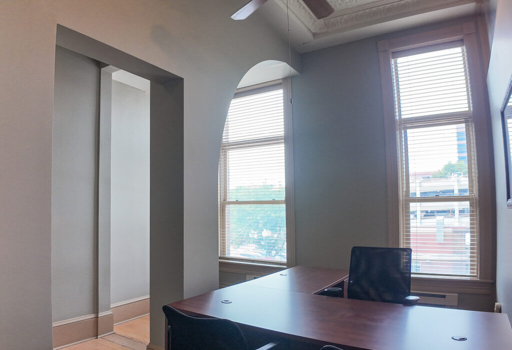 Private office with windows overlooking Phillips Avenue and historic arches