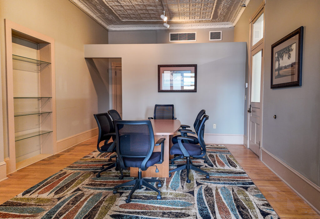 Conference or meeting area with exposed tin ceiling