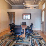 Conference or meeting area with exposed tin ceiling