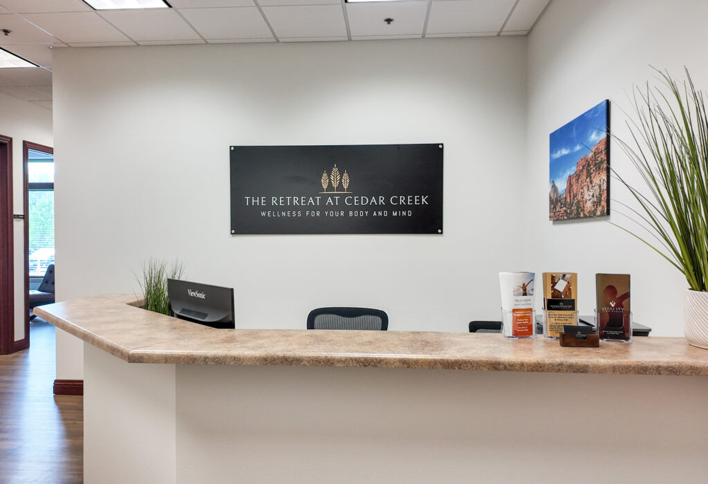 Front reception desk with waiting area and wood-look flooring