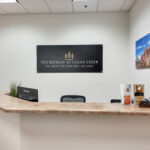 Front reception desk with waiting area and wood-look flooring