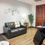 Private office with wood flooring and double doors