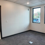 Private carpeted office with two exterior windows