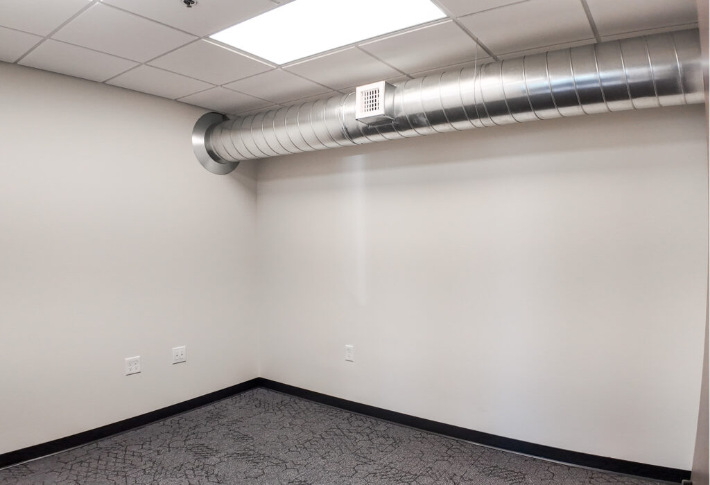 Interior private office with exposed HVAC ductwork
