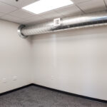 Interior private office with exposed HVAC ductwork
