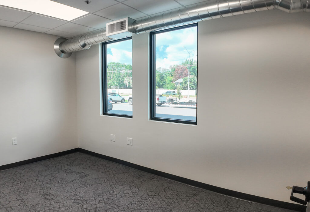 Private office with two windows overlooking the parking area