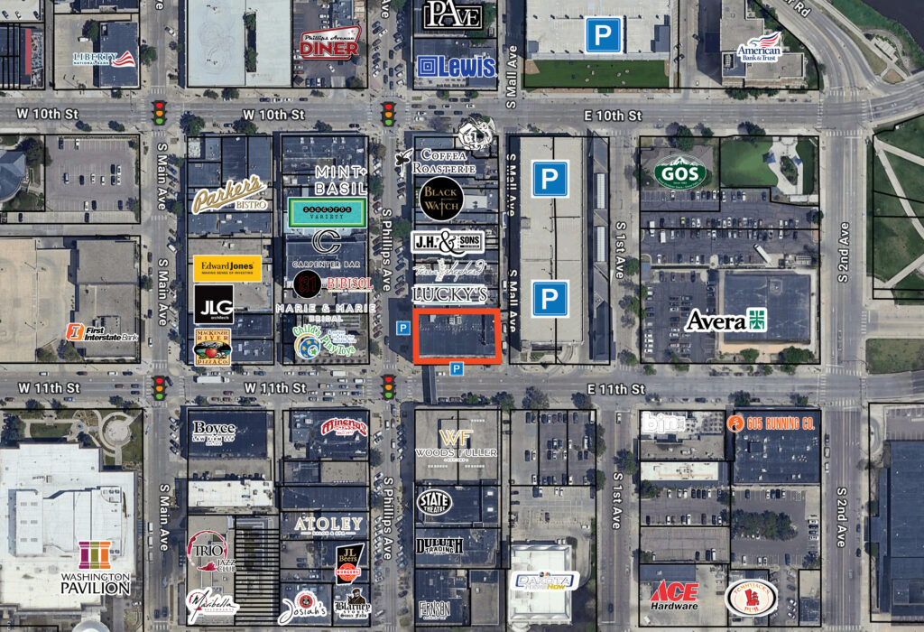 Aerial map showing Shriver Square Suite 203 outlined within the downtown Sioux Falls core, with adjacent parking garages and the Phillips Centre skywalk