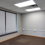Private office with window and carpeted flooring
