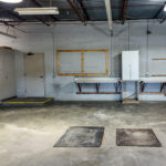Flex shop area with floor drainage and wall-mounted workspace