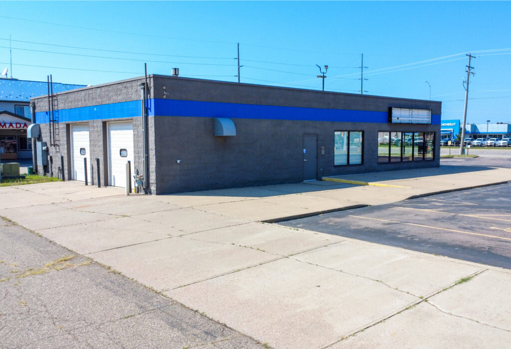 Exterior view of West 12th Street flex building with shop overhead doors