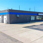 Exterior view of West 12th Street flex building with shop overhead doors
